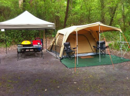 a tent and a picnic table in a field at WA Wilderness - one step from nature in Pemberton