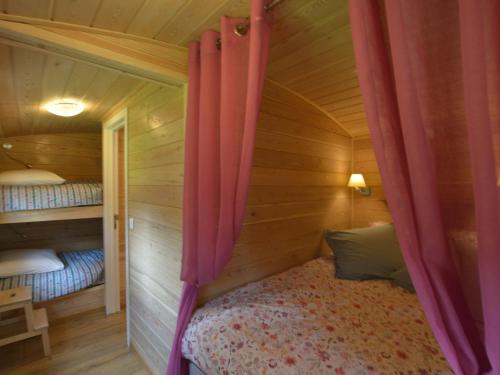 a bedroom with a bed in a wooden cabin at Charming Holiday Home in Malmedy with Sauna in Malmedy