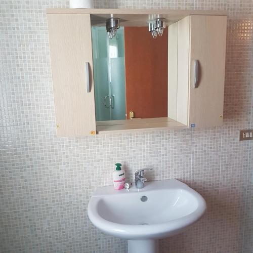 a sink in a bathroom with a mirror and a mirror at allery in Alba Adriatica