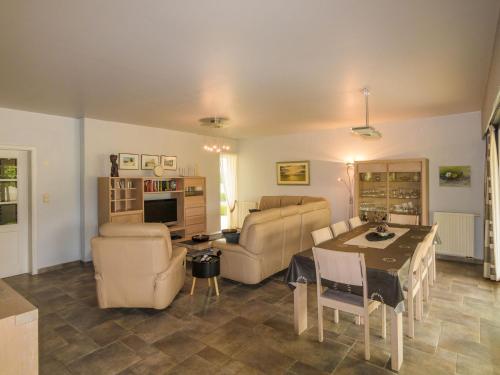 a living room with a couch and a table at Modern holiday home with swimming pool in Saint-Nexans