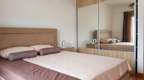 a bedroom with a bed and a mirror at Apartment Olive in Bar