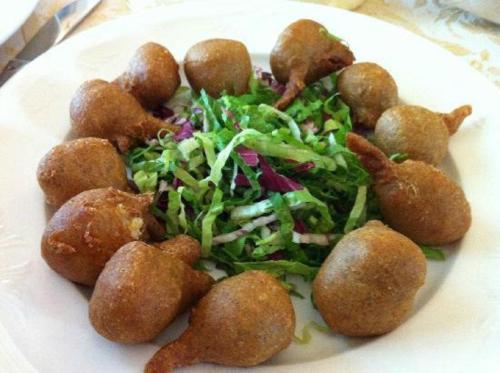 a white plate of food with a salad and rolls at Hotel Ristorante Miravalle in Teglio