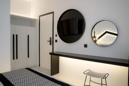 a room with a mirror and a black table and chair at Divelia Hotel in Perissa