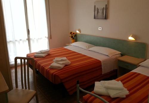 Ένα ή περισσότερα κρεβάτια σε δωμάτιο στο Albergo Santo Stefano
