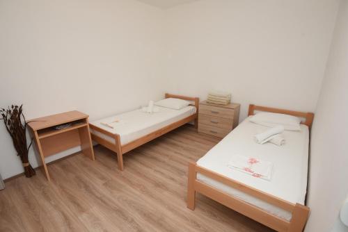 a small room with two beds and a desk at Apartment Ćukušić in Split