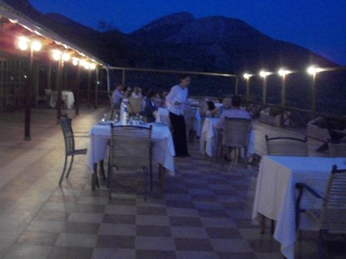 a group of people sitting at tables in a tent at La Petite Planete in Mykines