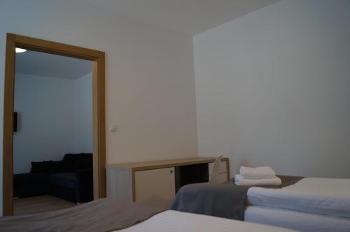 a room with two beds and a mirror at Ośrodek Turystyczny Warzenko in Warzenko