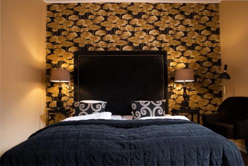 a bedroom with a large bed with a black headboard at Statt Hassleholm BW Signature Collection in Hässleholm