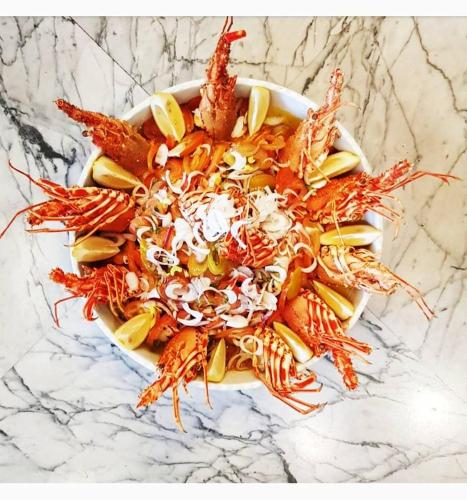 a plate of food with lobsters and other foods at Hotel Intervallo in Torre Lapillo