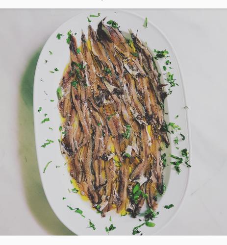 a plate of food on a white plate at Hotel Intervallo in Torre Lapillo