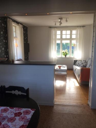 a living room with a couch and a table at Farbror Alfreds Sjöutsikt in Köpingsvik