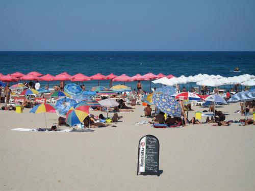a crowd of people on a beach with umbrellas at Sea'n'Pool Apartments in Hotel in Sozopol