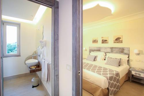 a bedroom with a bed and a sink in it at Villa Caruso in Ischia