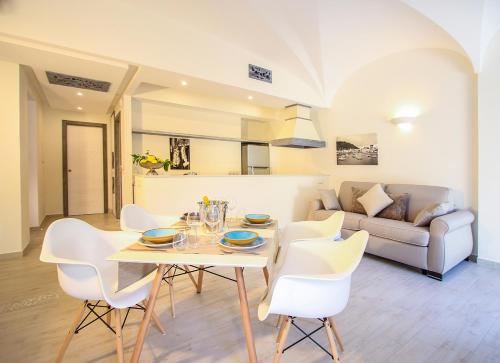 a living room with a table and chairs and a couch at Villa Caruso in Ischia