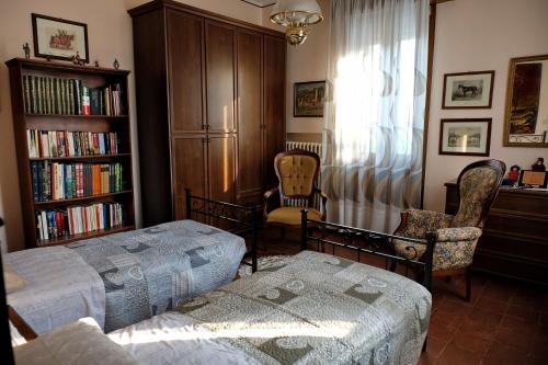 a bedroom with a bed and a book shelf at B&B "Il Cantastorie" Casa Molinari-Boldrini - Room & breakfast in Castelfranco Emilia