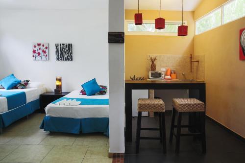 a room with a bed and a table and chairs at Eco del Mar in La Libertad