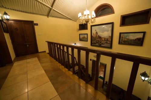 a staircase in a house with a chandelier at The Colonial Manek Manor in Mount Ābu