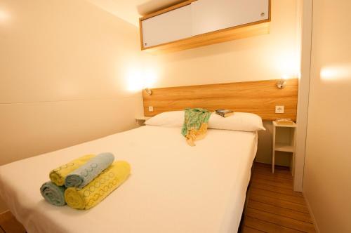 a bed room with a white bedspread and a white comforter at Camping Serenissima in Malcontenta