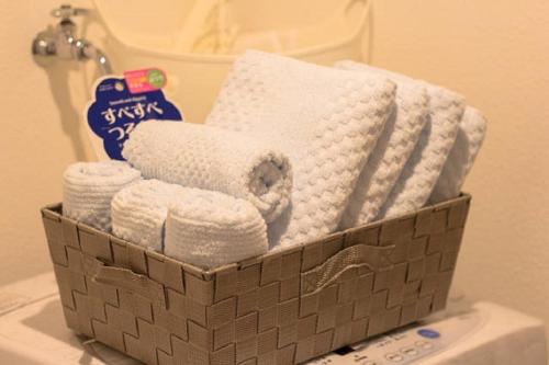 a basket filled with towels on top of a toilet at Forest Terrace Tenjinminami in Fukuoka