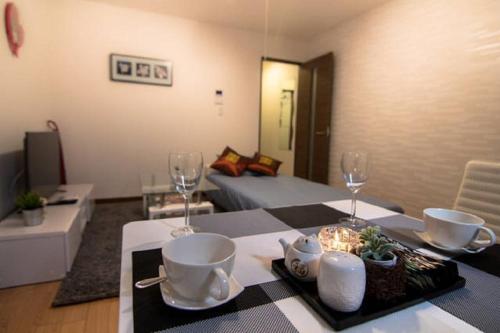 a living room with a table with wine glasses at Forest Terrace Tenjinminami in Fukuoka