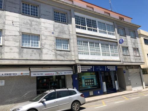 a silver car parked in front of a building at Pension Casa Prieto in Villalonga
