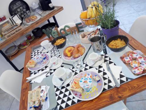 a table topped with plates of food and desserts at Il BorGhetto Guest House in Civitavecchia