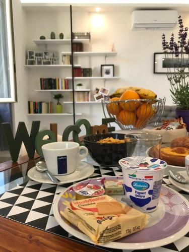 a table topped with plates of food and coffee at Il BorGhetto Guest House in Civitavecchia