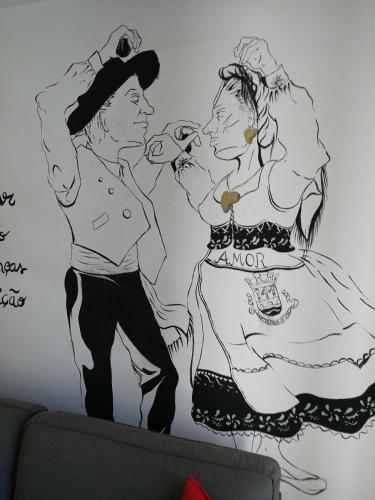 a drawing of two women on a wall at Casa da Travessa in Ponte de Lima