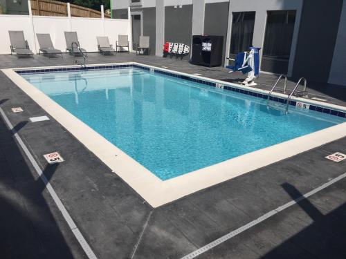 a swimming pool with blue water in a building at Wingate by Wyndham Louisville Airport Expo Center in Louisville