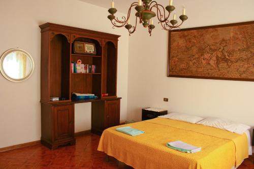 a bedroom with a bed and a wooden cabinet at Morianese Residence in Lucca