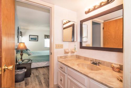 a bathroom with a sink and a bedroom at Beach House in Clearwater Beach