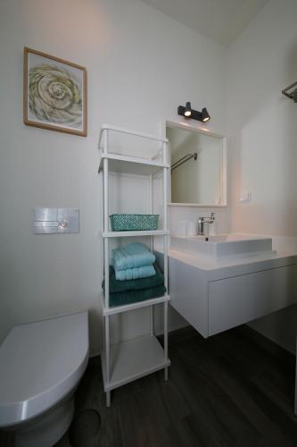 a white bathroom with a sink and a toilet at Casa Do Gilao in Tavira