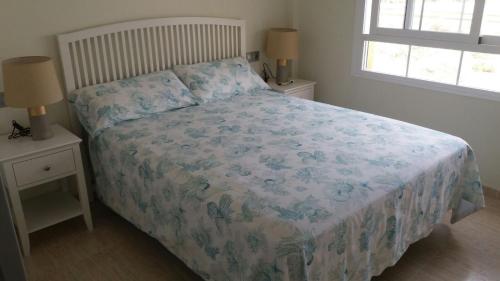 A bed or beds in a room at Apartments Sol de Almeria Golf y Playa