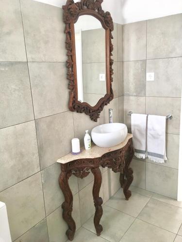 a bathroom with a sink and a mirror at Villa Zen - beautiful private pool-heating option, hot tub, beautiful garden in Albufeira