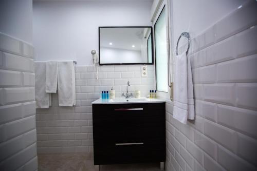 a bathroom with a sink and a mirror at Oriente Palace Apartments in Madrid