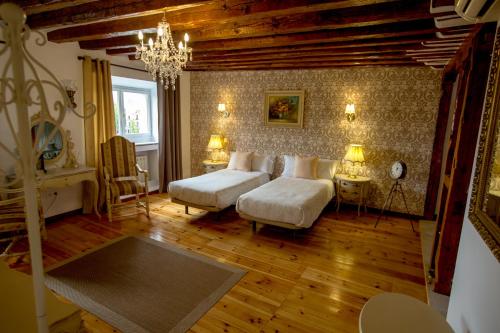 a bedroom with a bed and a chandelier at Oriente Palace Apartments in Madrid