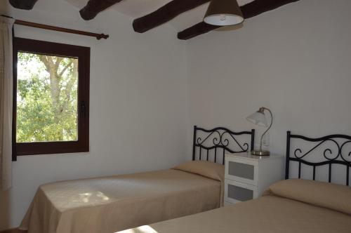 A bed or beds in a room at Mas de Bruquet