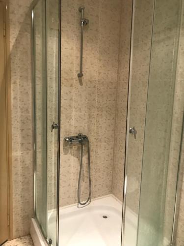 a shower with a glass door in a bathroom at Hotel AVALON in Nesebar