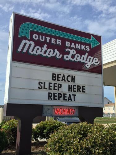 a sign for a winter bank winter lodge with a sign for a beach sleepeper at Outer Banks Motor Lodge in Kill Devil Hills