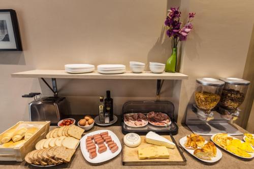 a table with plates of food on a counter at Cuneo Hotel in Cuneo