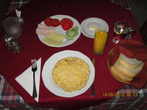 a table with plates of food on a table at Kisherceg Szálláshely in Budapest