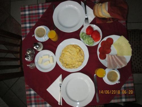 a table with plates of food on a red table at Kisherceg Szálláshely in Budapest