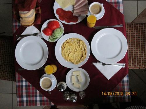 a table with plates of food and drinks on it at Kisherceg Szálláshely in Budapest