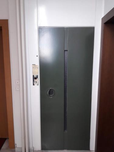 a metal elevator in a room with a door at Lion Apartment Sunset in Thessaloniki