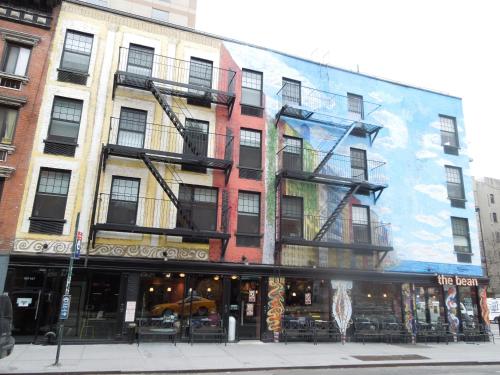 a building with a mural on the side of it at East Village Hotel in New York