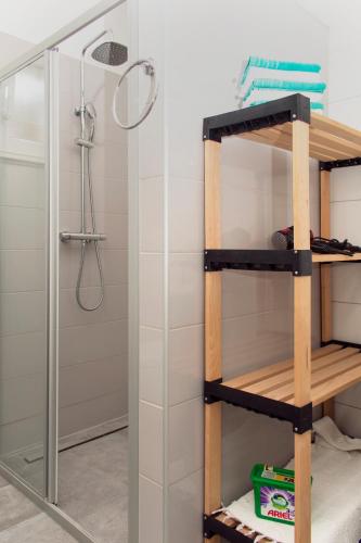 a shelf in a bathroom with a shower at Holiday Home Andrija in Podstrana