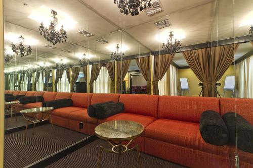a living room with a red couch and tables at Sapphire in South Padre Island