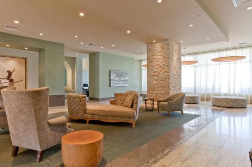 a lobby with chairs and tables in a building at Sapphire in South Padre Island