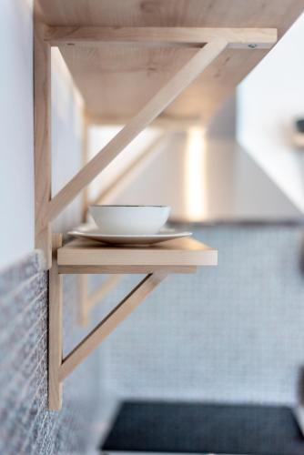 a bowl on a plate on a wooden shelf at Etesians Suites & Villas in Super Paradise Beach