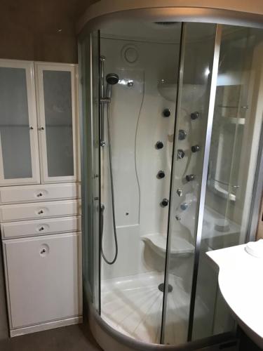 a bathroom with a shower with a glass shower stall at Apartment Windsor in Adeje